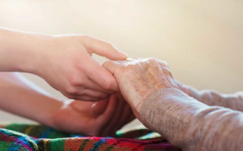 elderly hands holding younger hands, hand holdin